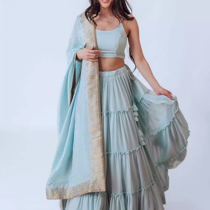 Elvia Sky Blue Shimmer Tiered Lehenga choli with Gold Accents