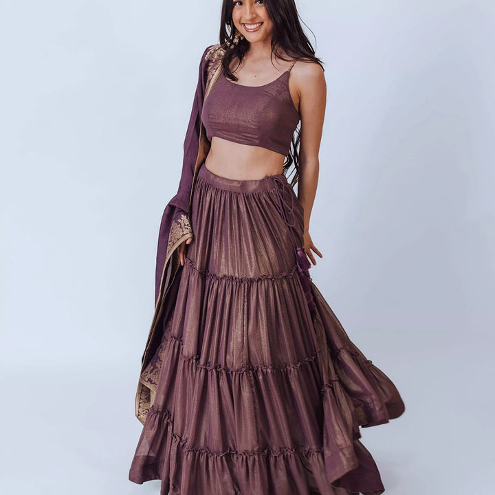 Gaia Brownish Purple Shimmer Tiered Lehenga set with Gold Accents