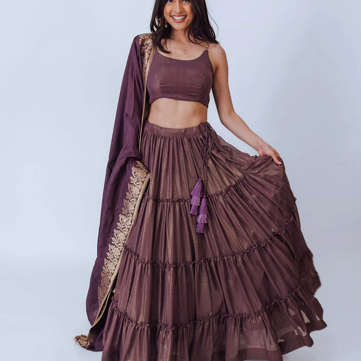 Gaia Brownish Purple Shimmer Tiered Lehenga set with Gold Accents