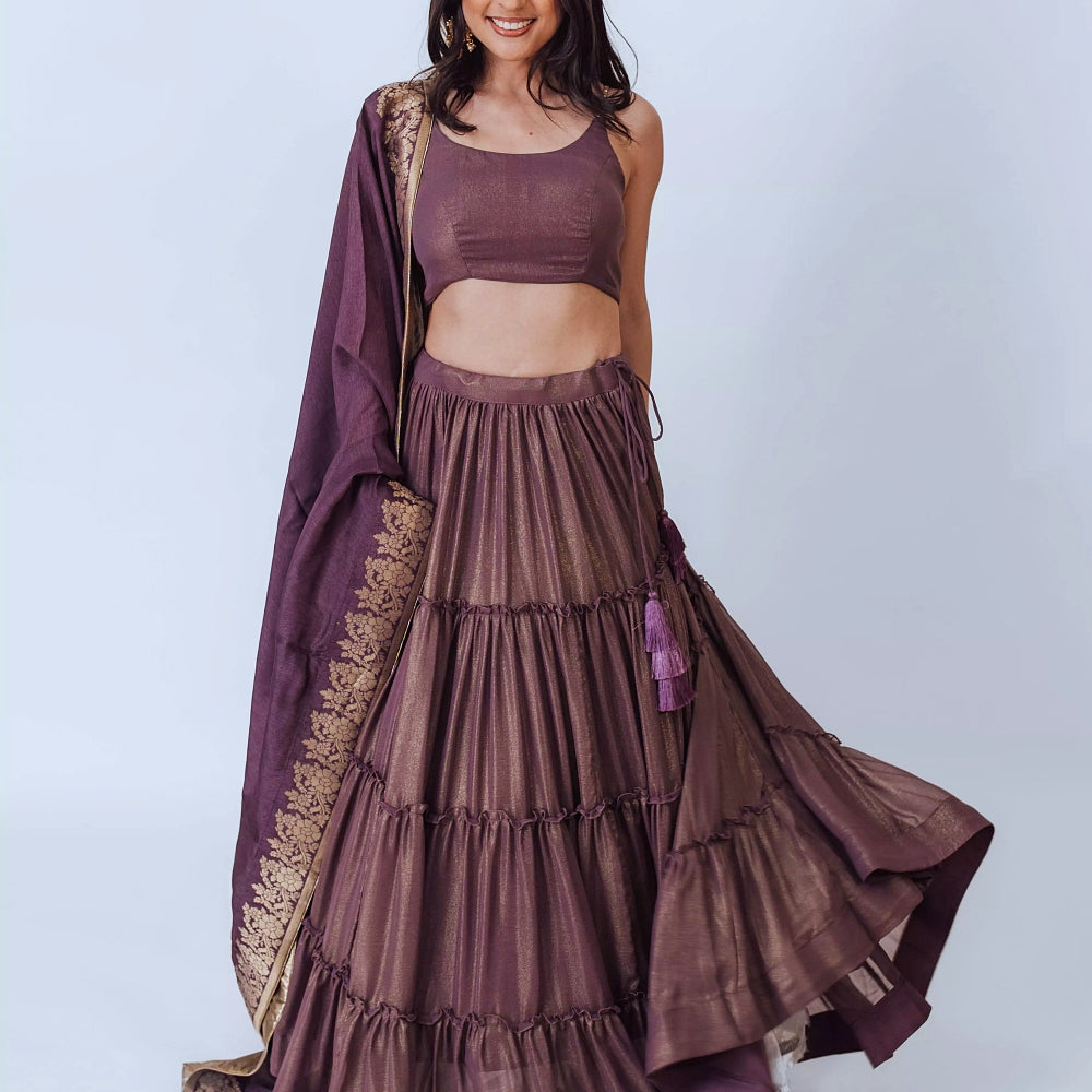 Gaia Brownish Purple Shimmer Tiered Lehenga set with Gold Accents