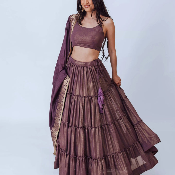 Gaia Brownish Purple Shimmer Tiered Lehenga set with Gold Accents