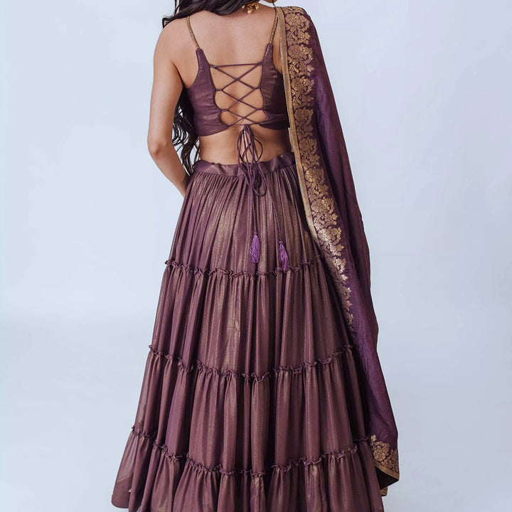 Gaia Brownish Purple Shimmer Tiered Lehenga set with Gold Accents