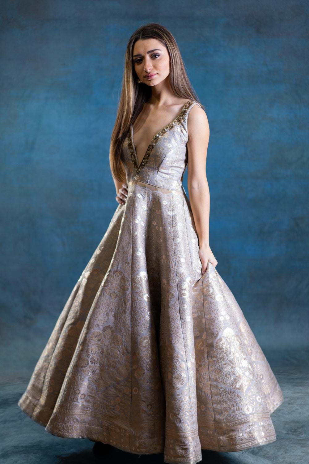 Jacquard silk A-line gown with deep plunge neckline and hand embroidered zardoshi work.