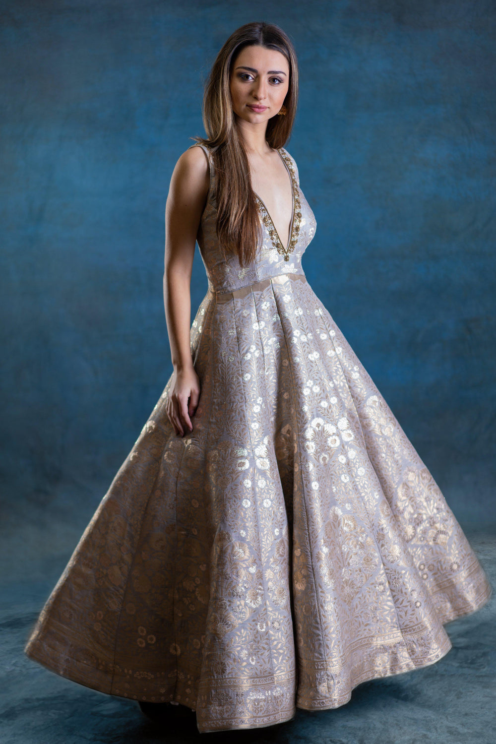 A-line jacquard silk gown with gold woven patterns, deep plunge neckline, and hand-embroidered zardoshi work.