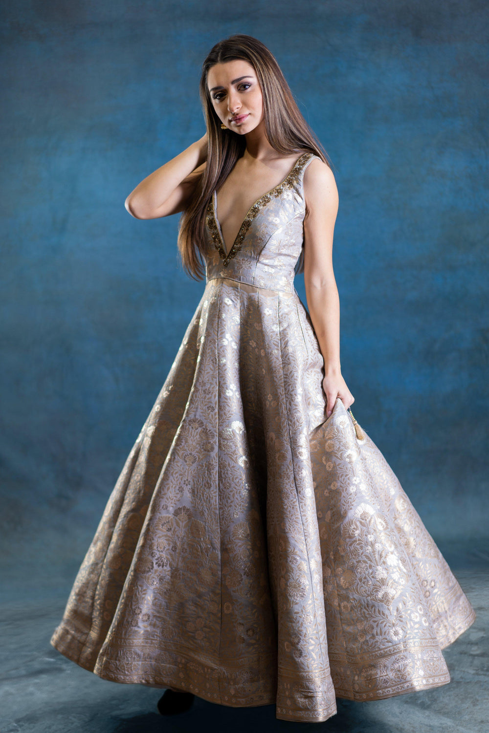Jacquard silk A-line gown with deep plunge neckline and gold zardoshi hand embroidery.