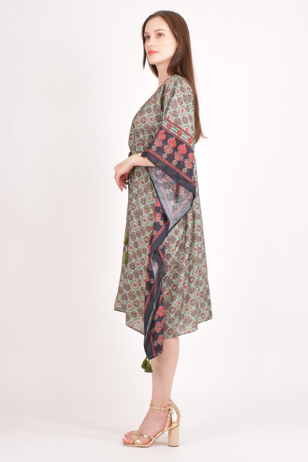 Model wearing a green Ajrakh print muslin silk kaftan with embroidered V-neck and floral sleeves.