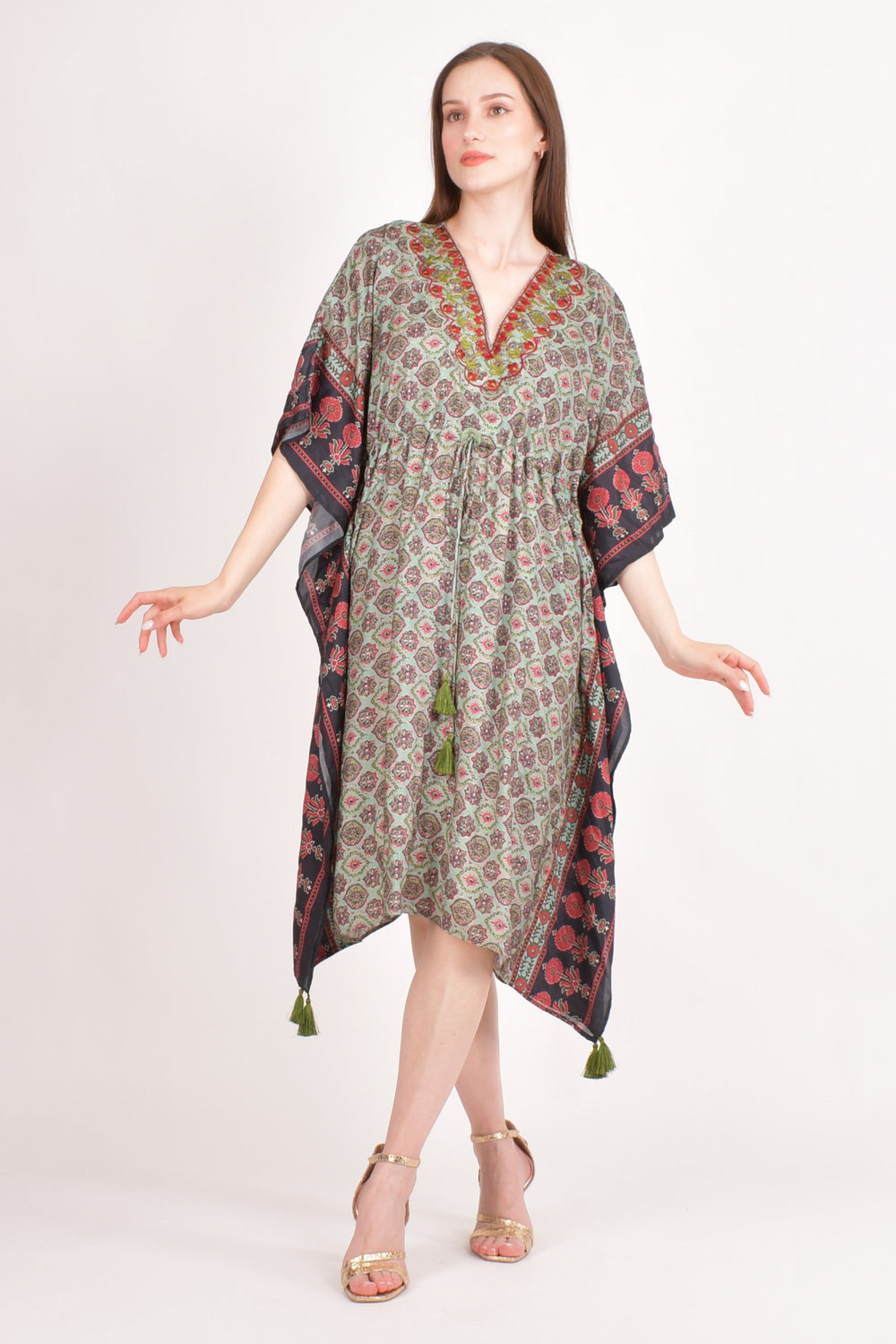 Woman models a green Ajrakh print muslin silk kaftan with embroidered V-neck and drawstring waist.