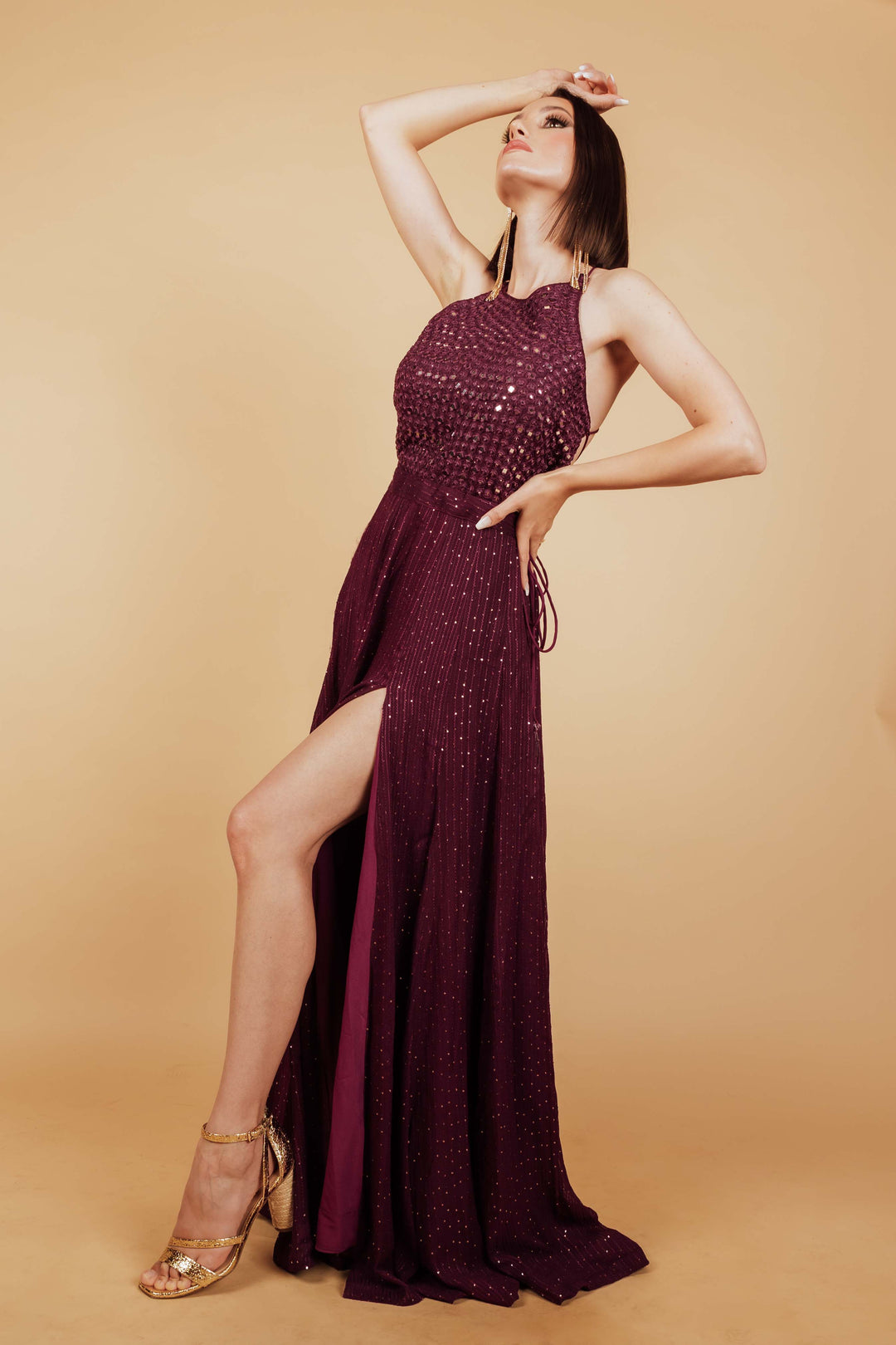 Front photo of a model wearing maroon gown by raas