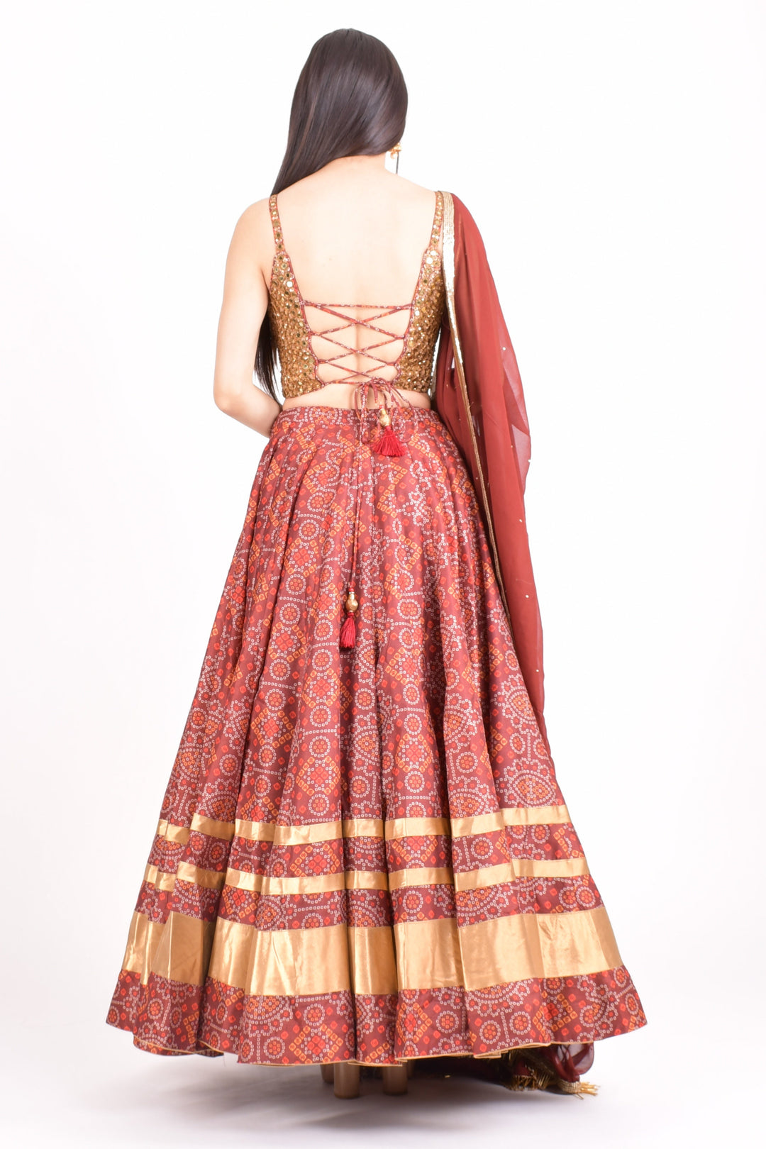 Bandhani print Chaniya Choli with hand-embroidered blouse, lace-up back, and matching dupatta.