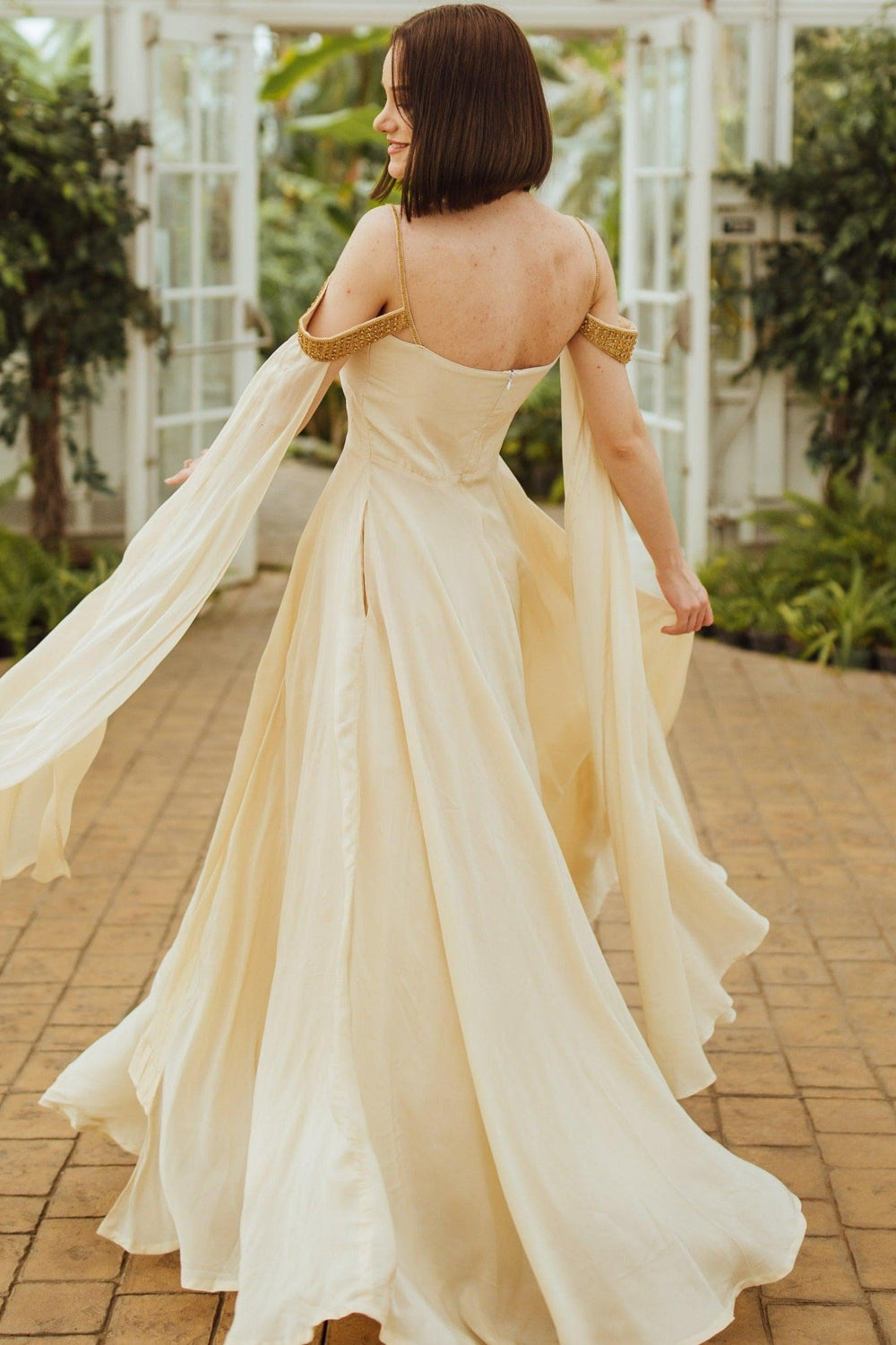 Tara Beige Long Silk Dress with flowing capes and a stylish slit.