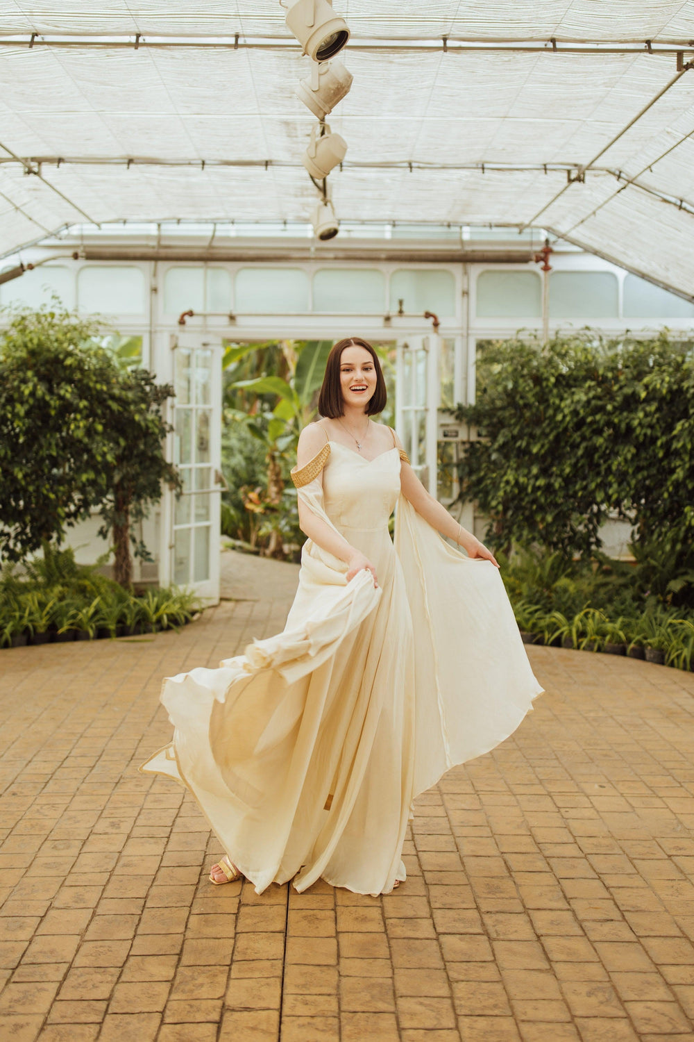 Tara Beige Long Silk Dress with Slit and Draped Capes on Sleeves.