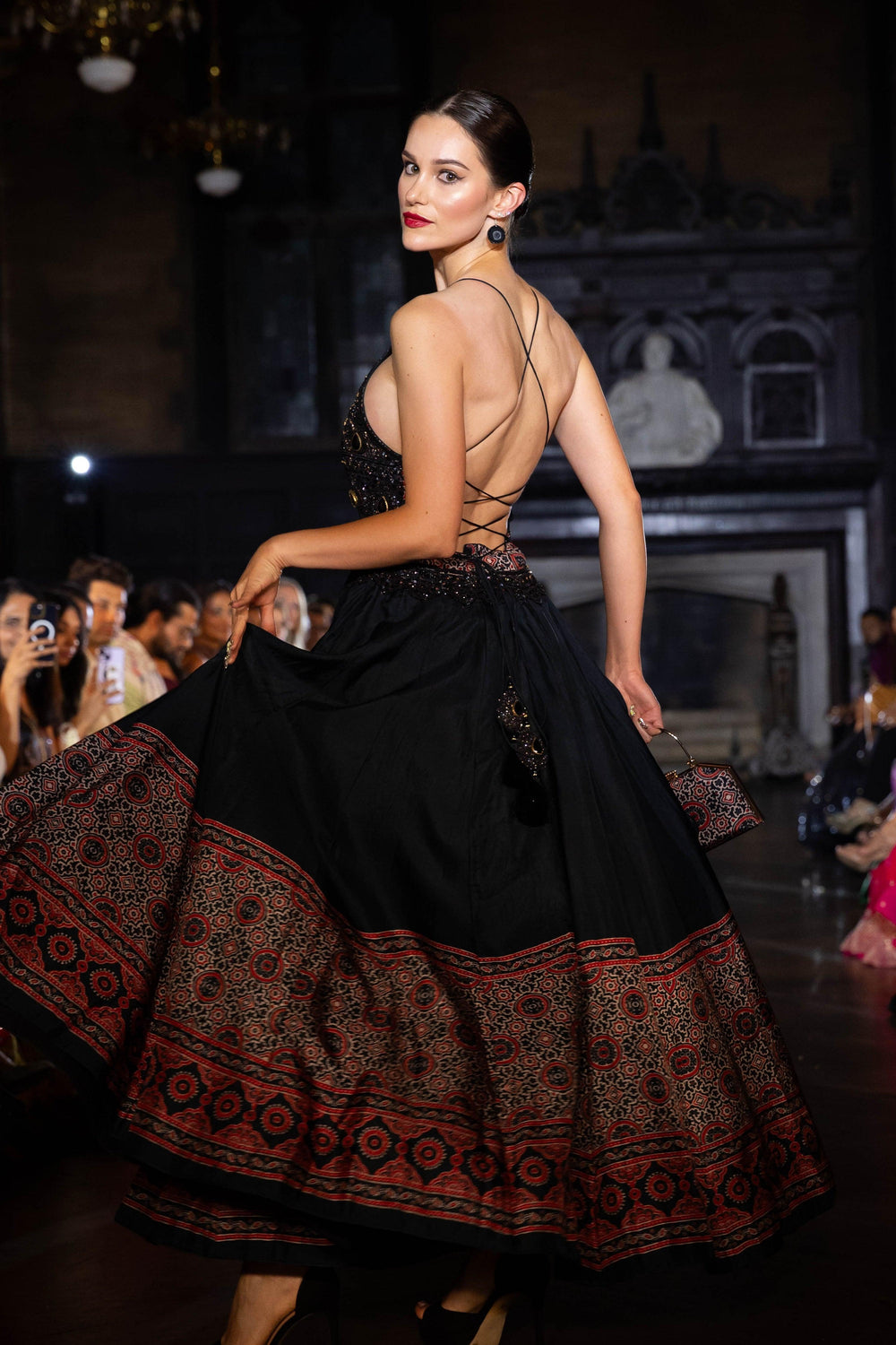 Black silk Ajrakh long dress with heavy hand-embroidered stone and resham work, V-neck, and back zipper.