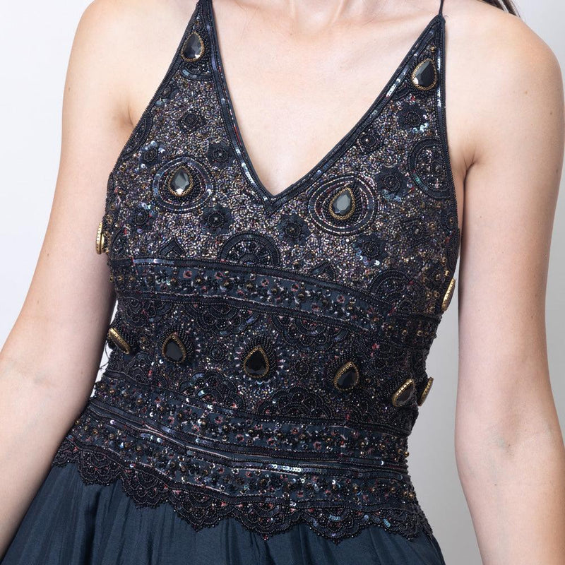 Black silk gown with heavy hand-embroidered stone and resham work, V-neckline, and ajrakh print skirt.