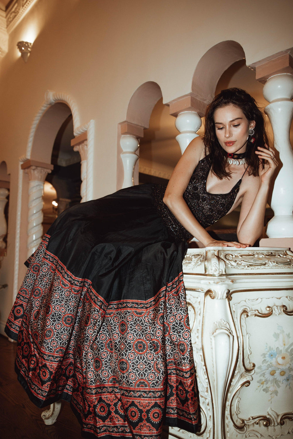 Black silk Ajrakh long dress with heavy hand embroidery, V-neckline, and contrasting printed skirt.