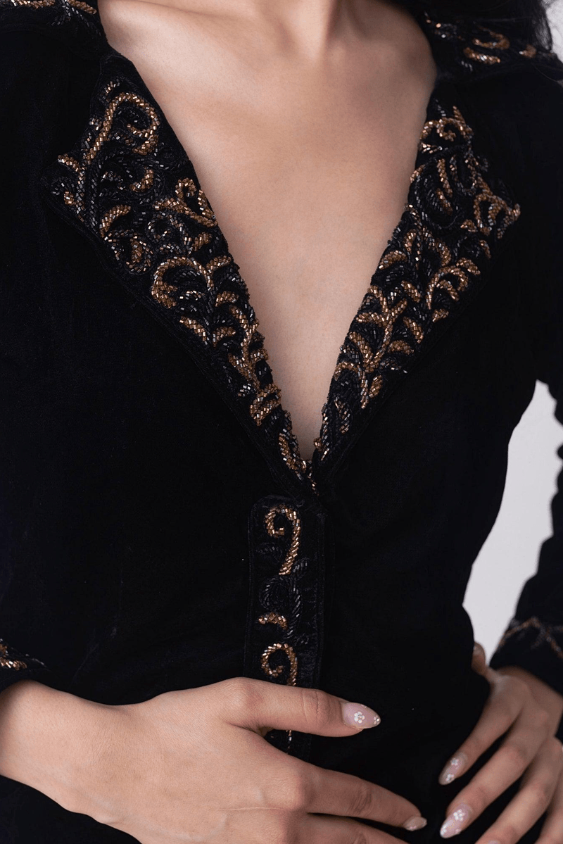 Black velvet blazer dress with intricate gold hand embroidery on the collar, centerline, and sleeves.
