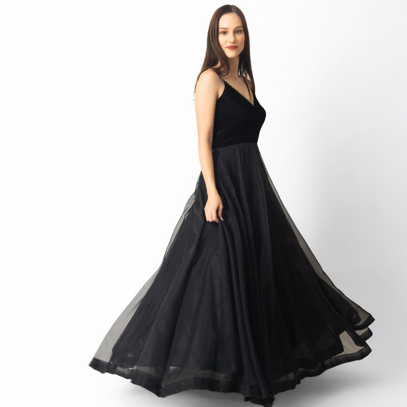Black velvet and organza gown with hand-embroidered golden neckline, A-line silhouette.