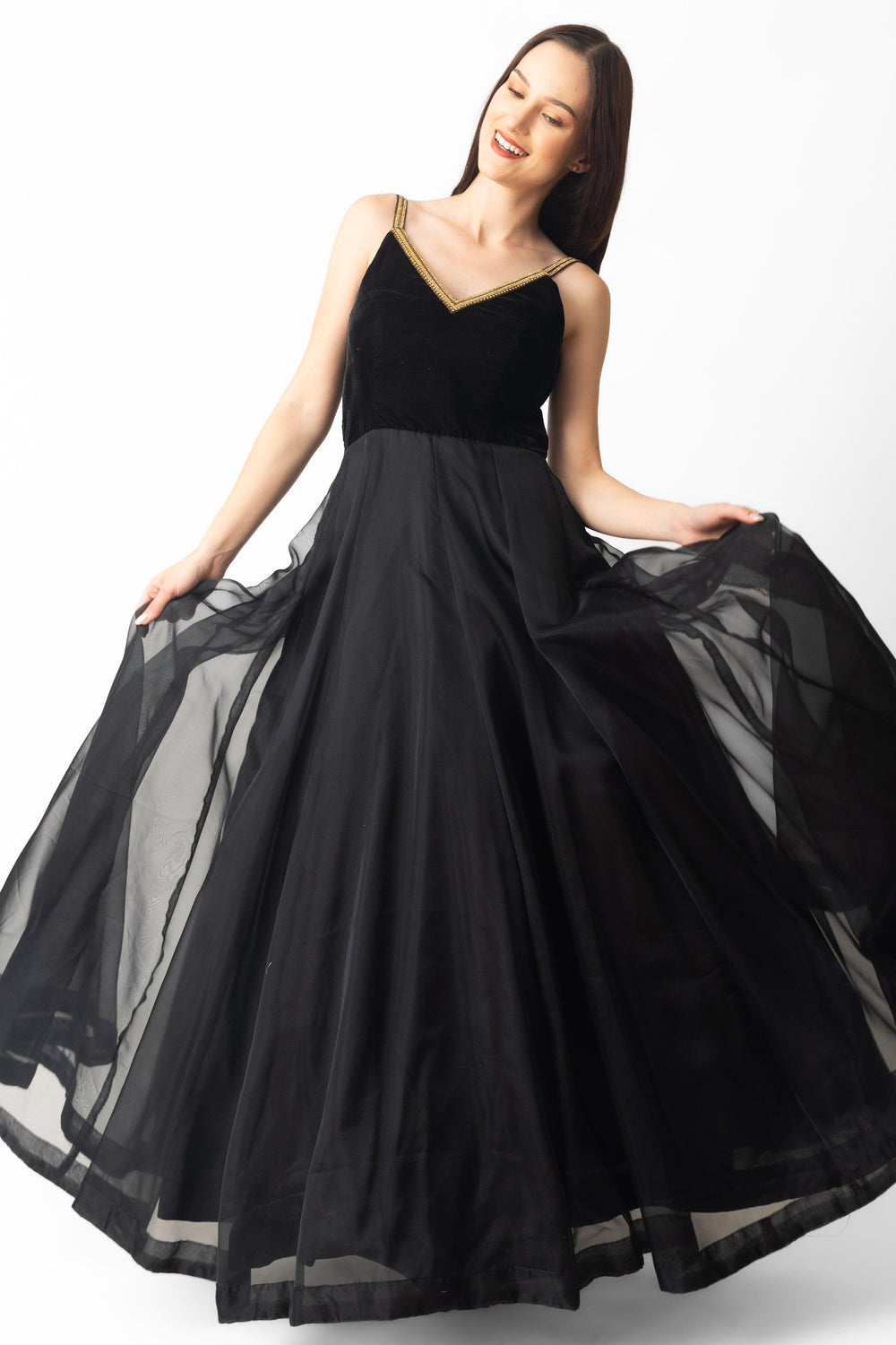 Black velvet and organza gown with golden hand-embroidered V-neckline, A-line silhouette, 58" length.