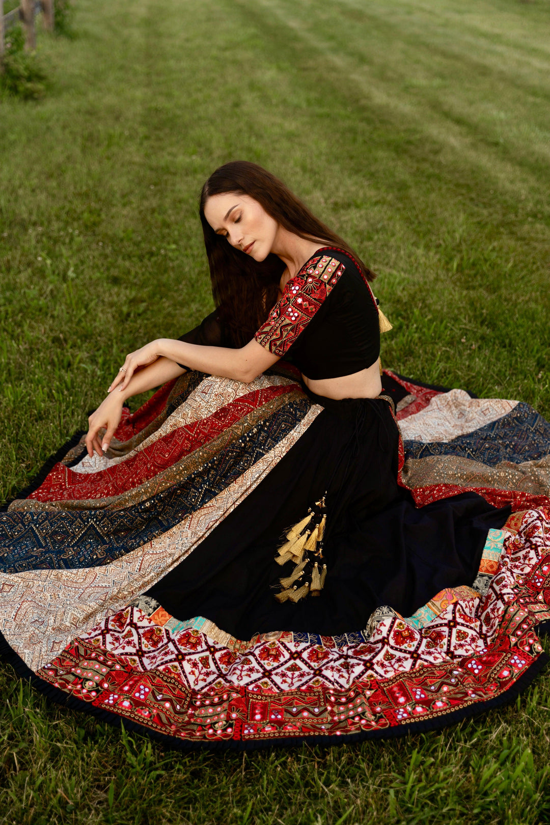 Black silk lehenga choli with multi-colored side panel, embroidered blouse, and dramatic flare for Garba.
