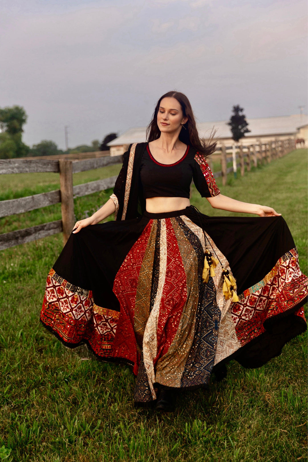 Black silk lehenga choli with multi-colored side panel, embroidered border, and matching blouse, perfect for Garba.