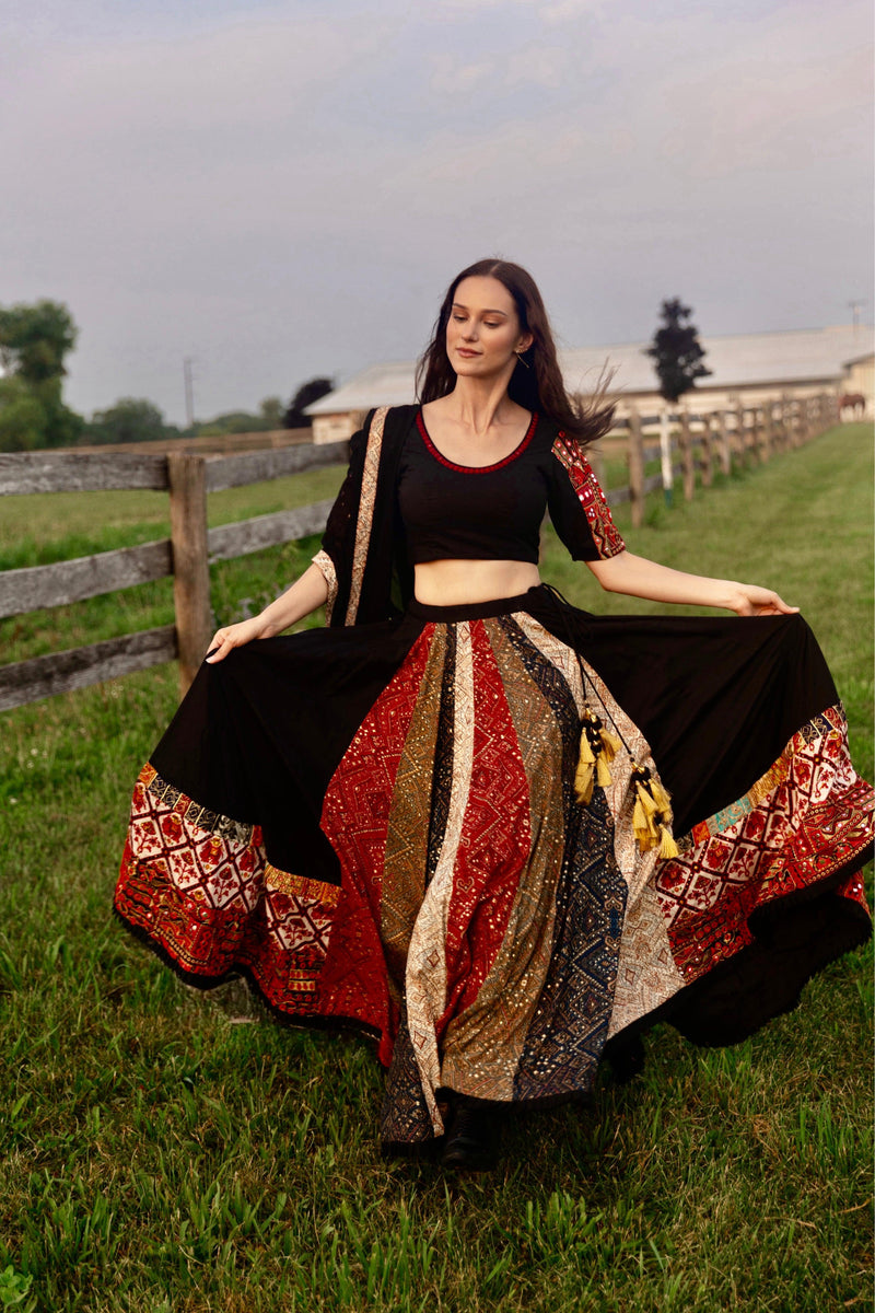 Black silk lehenga choli with multi-colored side panel, embroidered border, and matching blouse, perfect for Garba.
