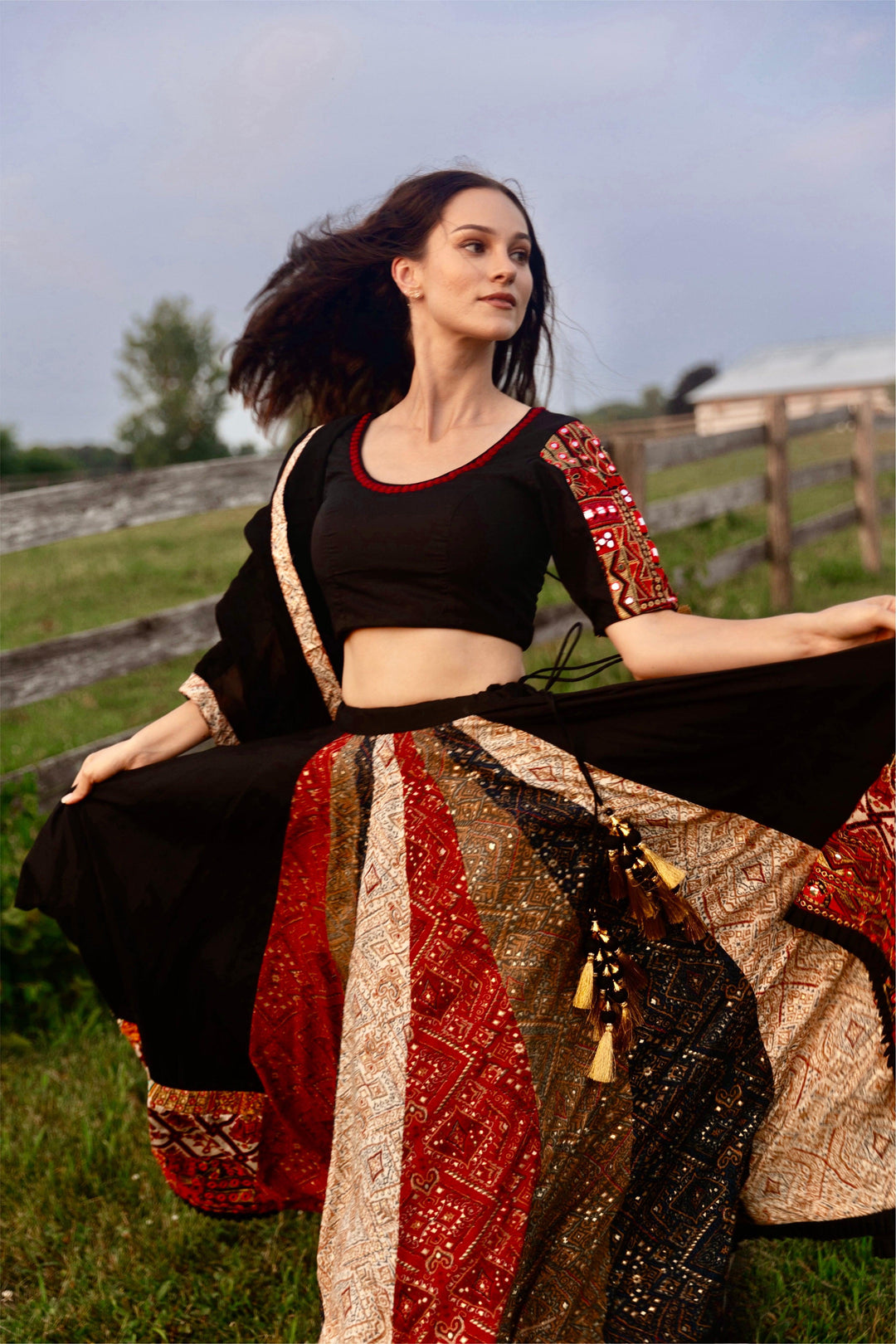 Andes Black Lehenga Choli Set with dramatic twirl, multi-colored side panel, and embroidered blouse.