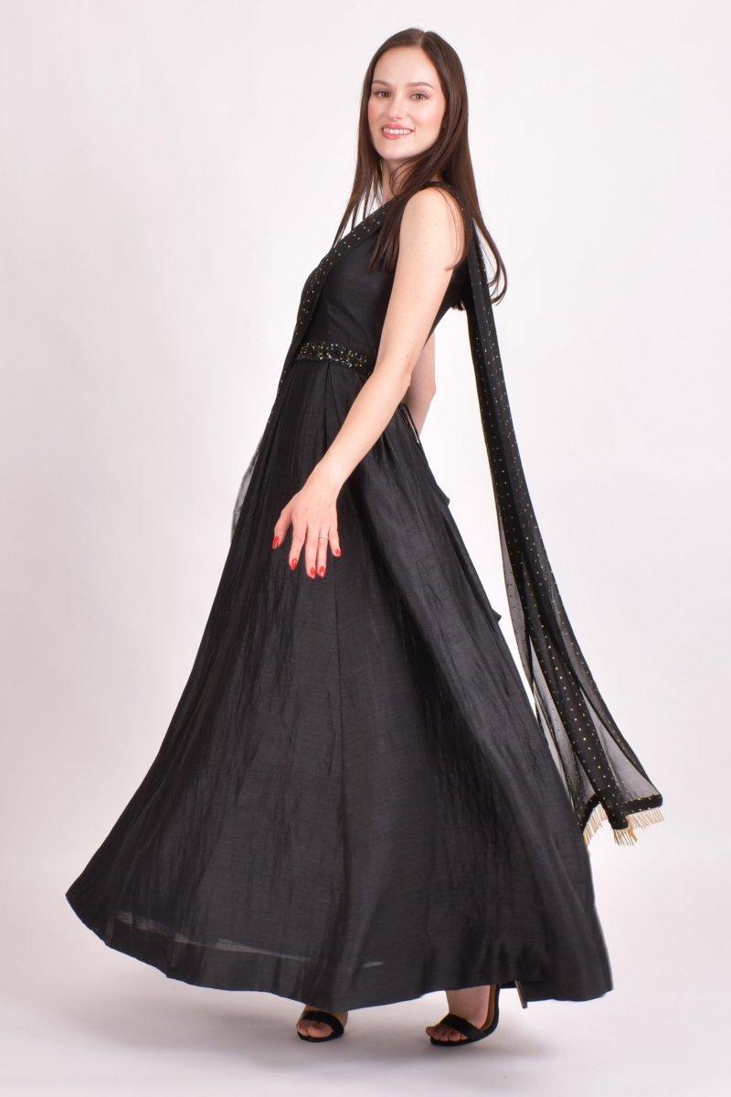 Black raw silk one-shoulder saree gown with intricate hand embroidery, attached mukaish work drape, and golden details.