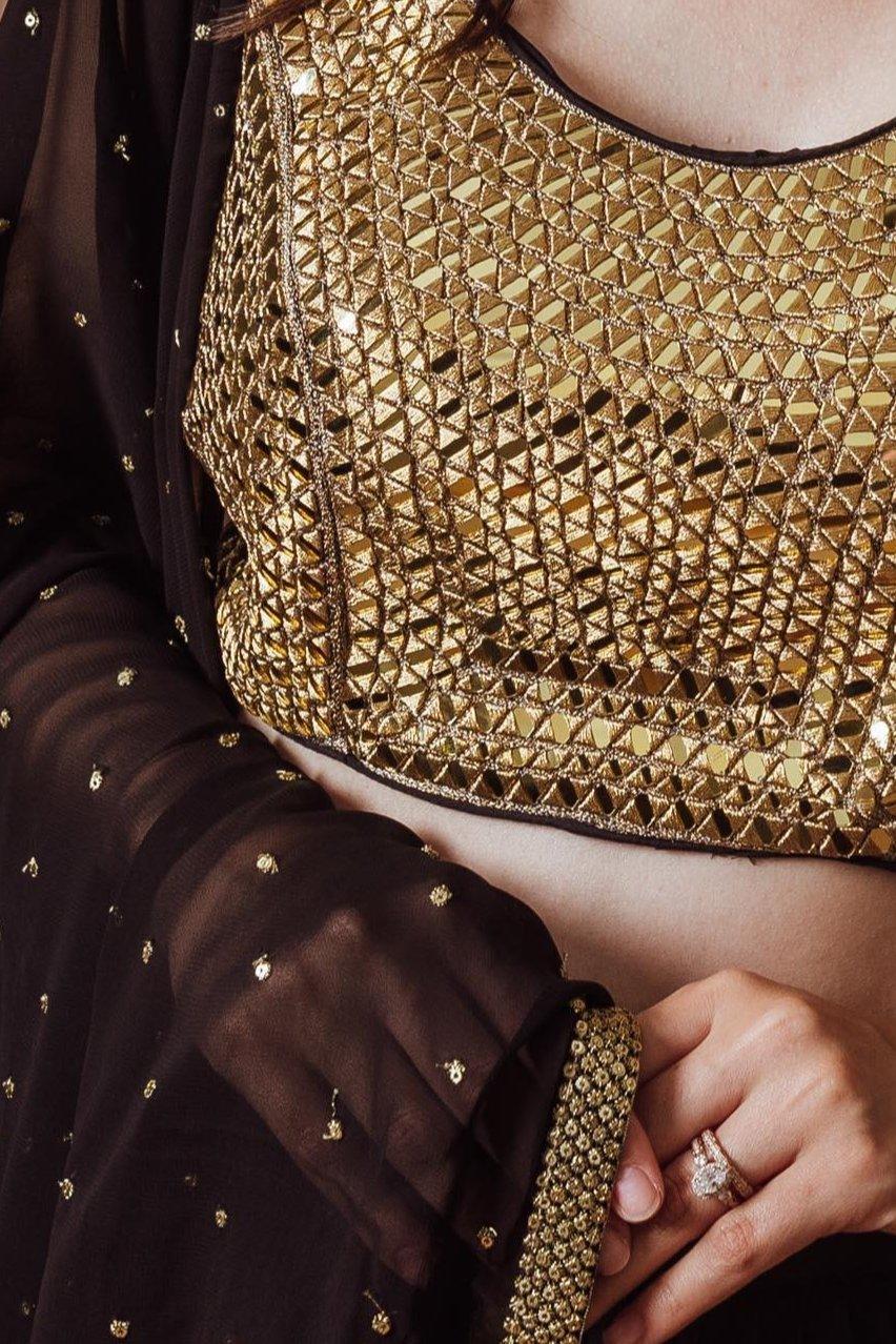 Black and gold Victoria Lehenga with mirror-embroidered blouse, georgette dupatta. Perfect for Garba styles.