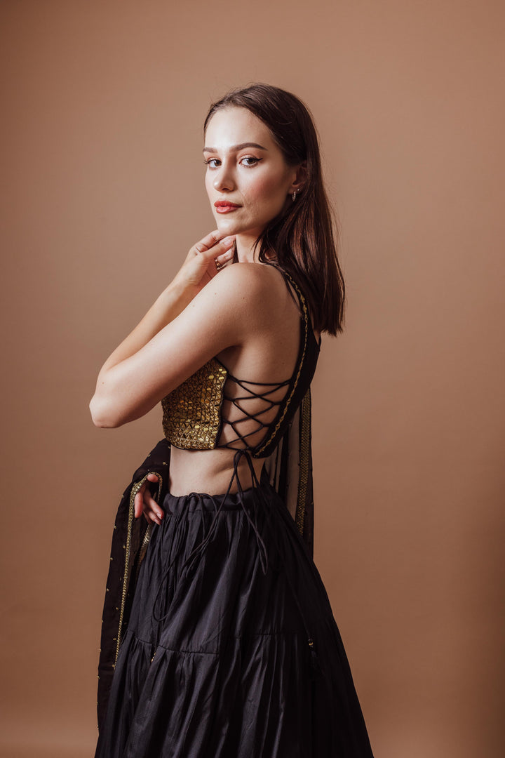 Victoria Black and Gold Lehenga with mirror work blouse, lace-up back, and flowing black skirt, perfect for Garba.