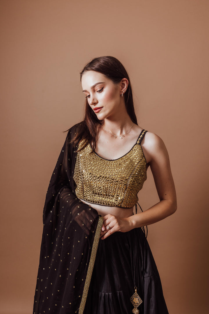 Victoria Black and Gold Lehenga Set, sleeveless mirror-embroidered blouse, black silk lehenga, georgette dupatta.