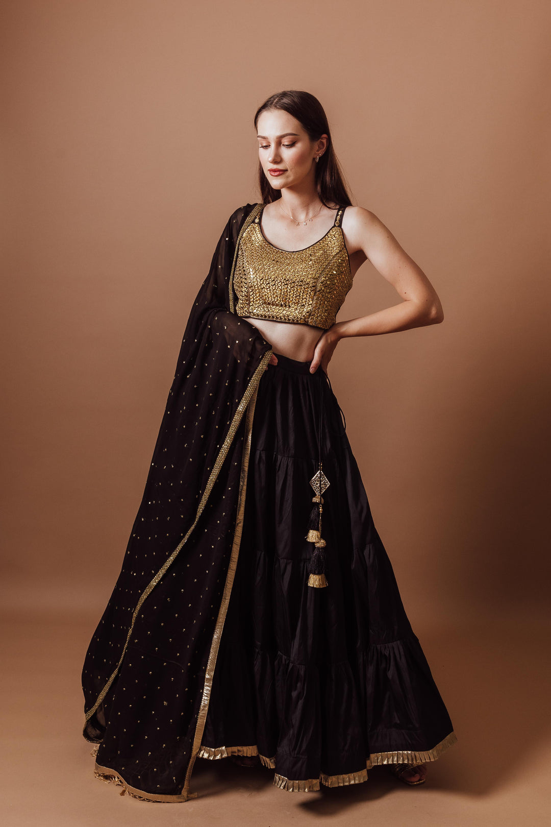Black and gold silk georgette lehenga set with mirror-embroidered blouse, perfect for Garba styles.