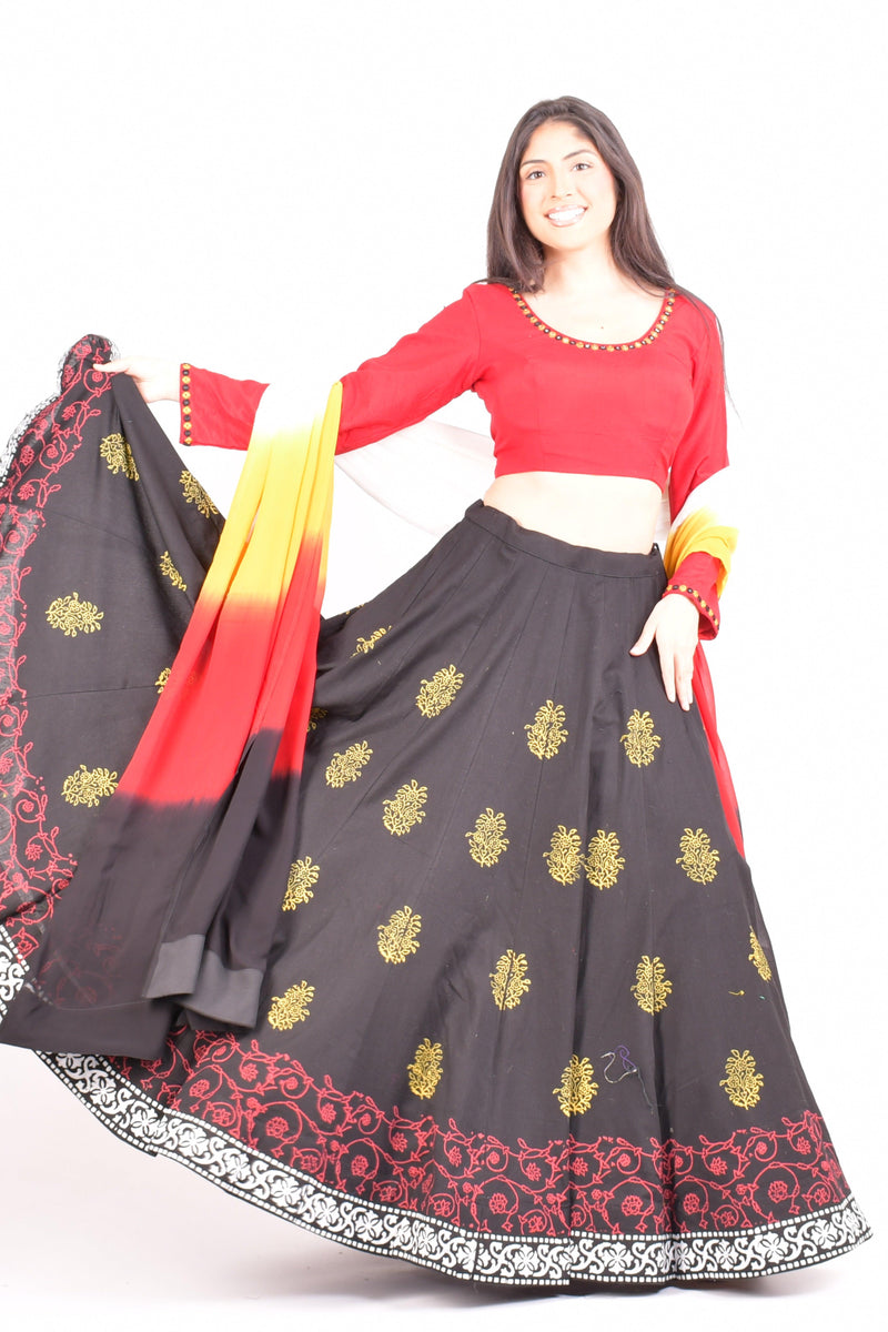 Black and red cotton Chaniya Choli set with a dramatic twirl, long-sleeve blouse, and shaded dupatta.