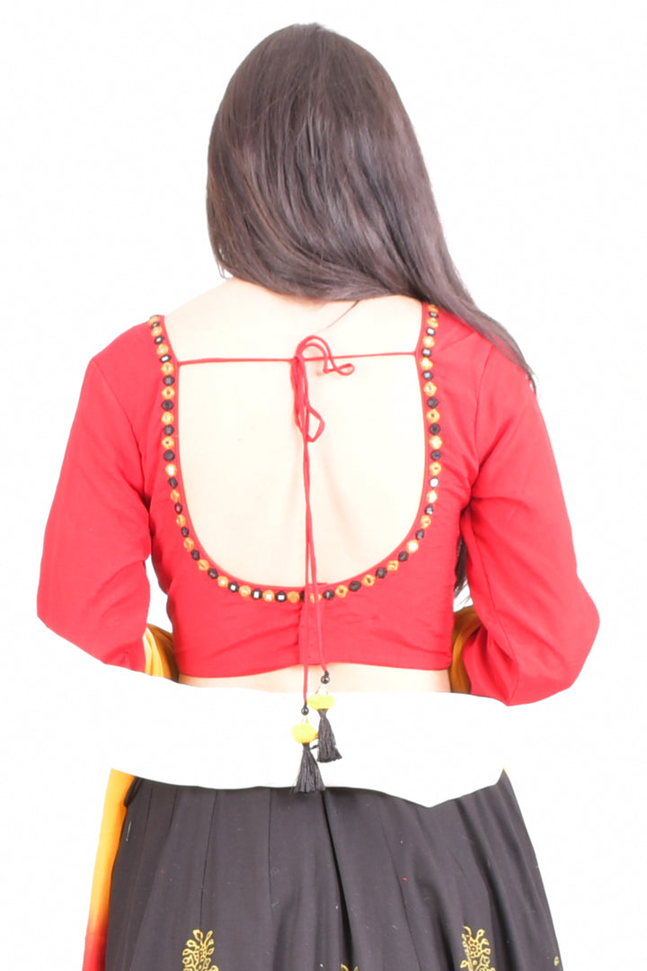 Woman in a red long-sleeve U-back blouse with gold embroidery, black lehenga, and white dupatta.