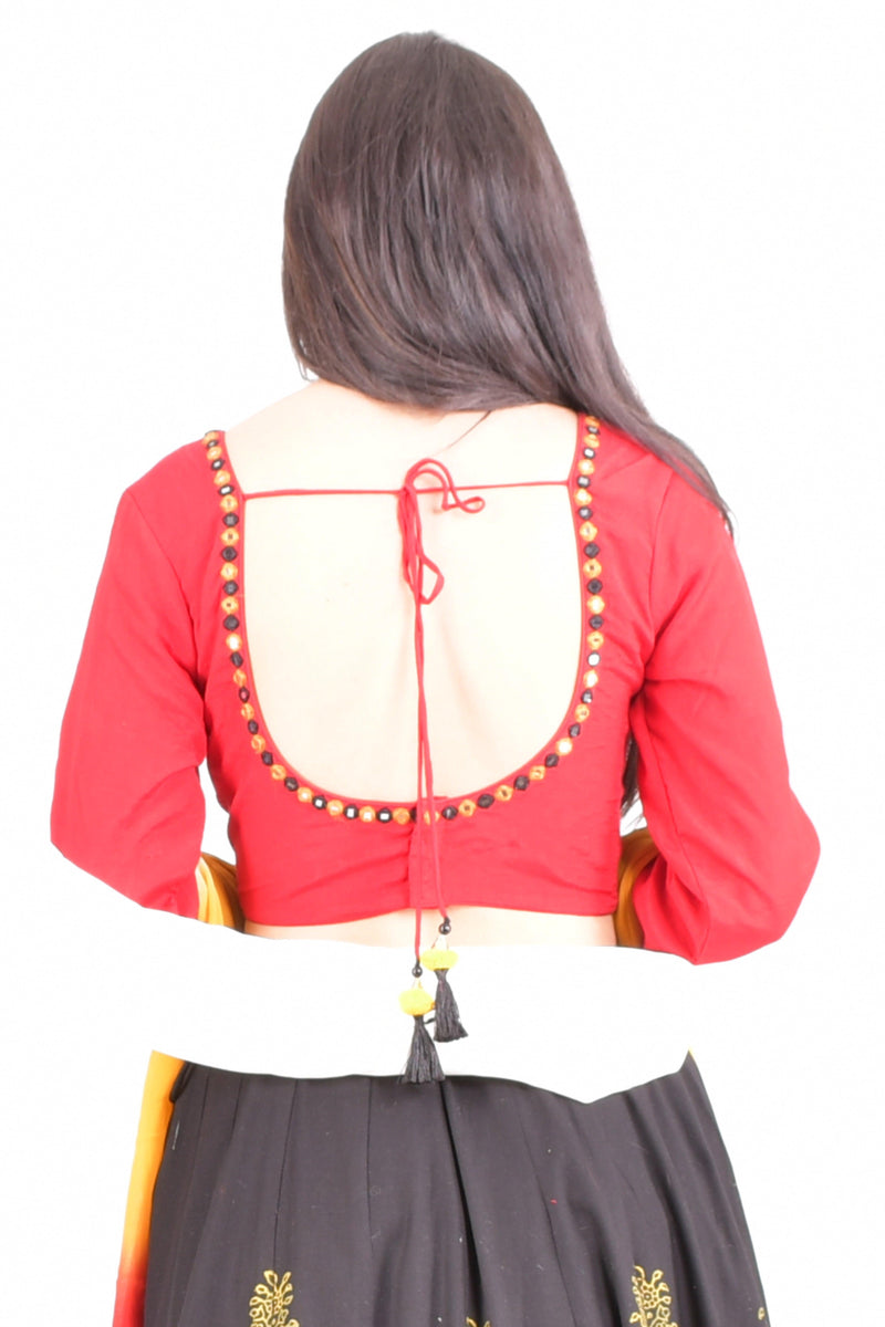 Woman in a red long-sleeve U-back blouse with gold embroidery, black lehenga, and white dupatta.
