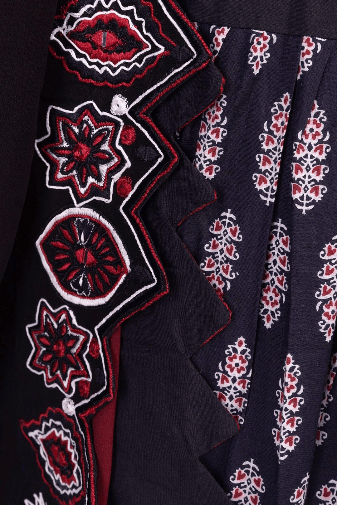 Black & red silk lehenga choli with intricate embroidery, perfect for dramatic twirls & Garba.