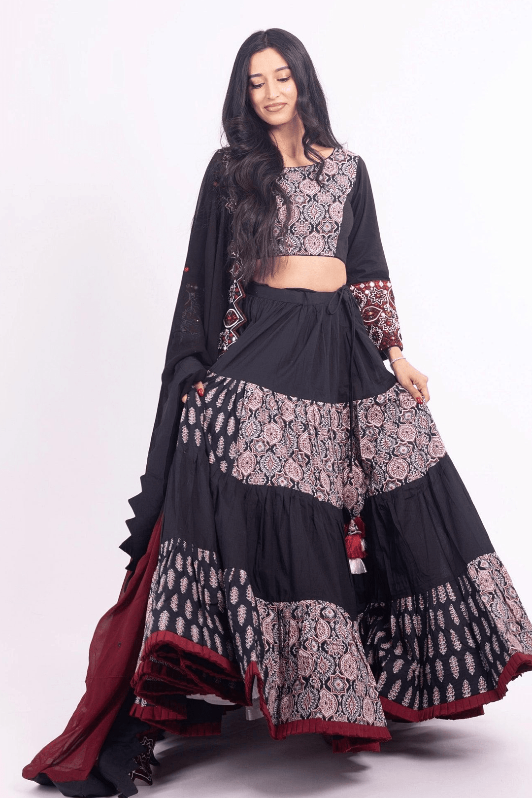 Black and red silk tiered lehenga choli set with embroidered blouse and dupatta, perfect for Garba.