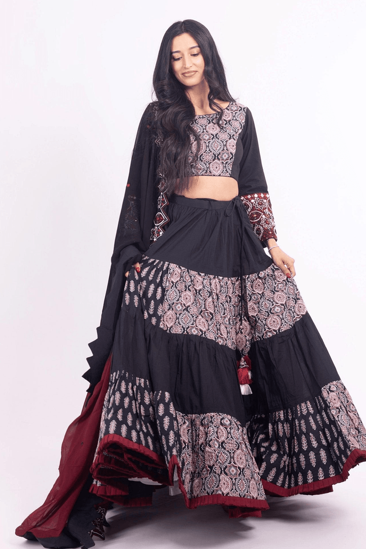 Black and red silk tiered lehenga choli set with embroidered blouse and dupatta, perfect for Garba.