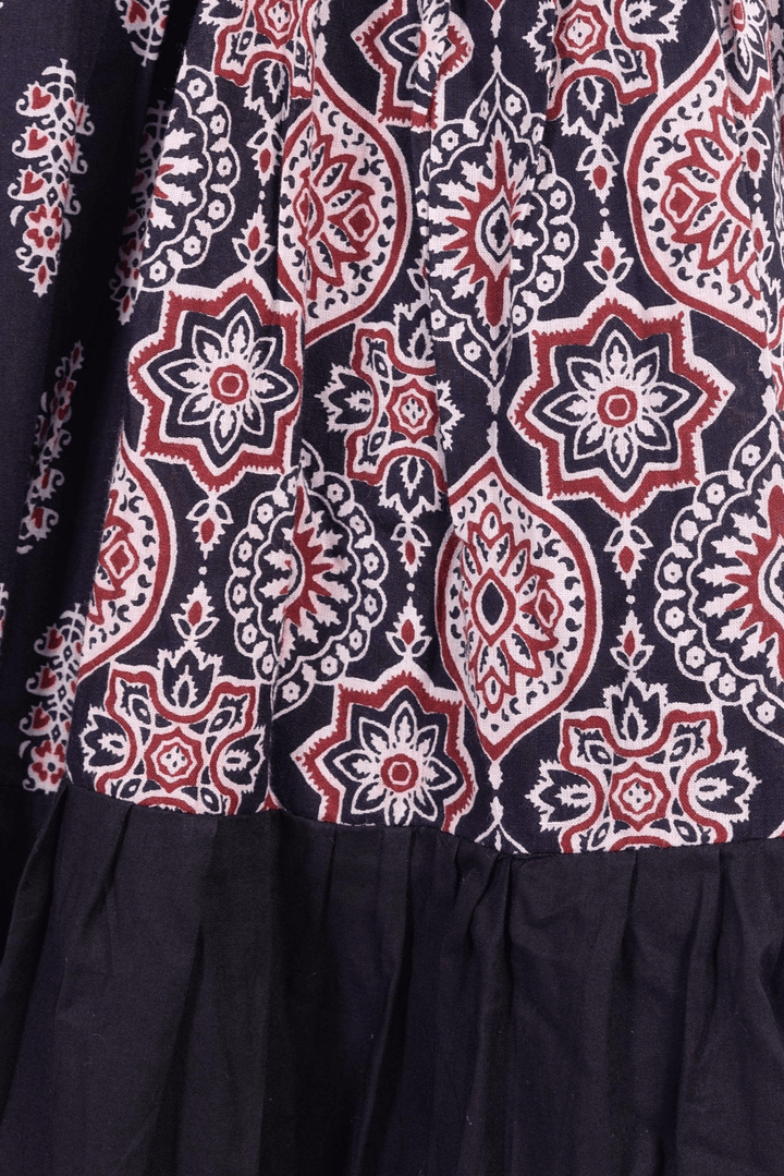 Black and red hand block-printed silk tiered lehenga with a dramatic twirl, perfect for Garba.