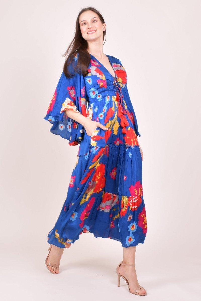 Blue chiffon maxi dress with vibrant floral print, angel sleeves, tiered ruffle skirt, and lace-up tassel bodice.