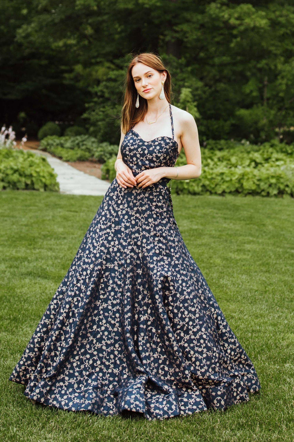 Blue silk brocade convertible A-line gown with halter neck, intricate weaving, and flowy skirt.