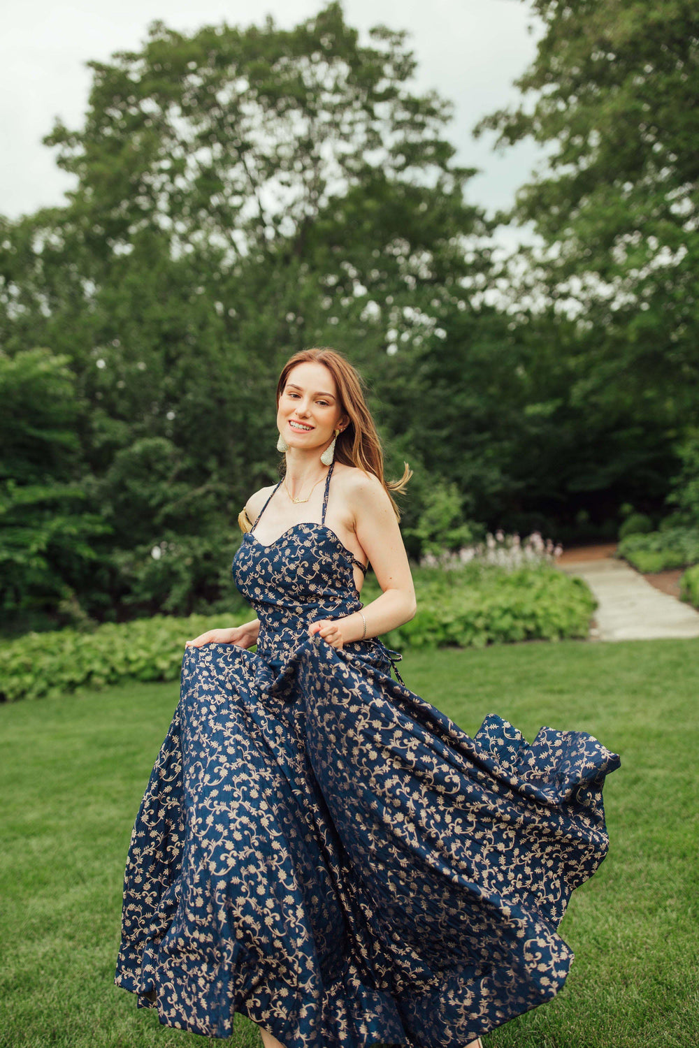 Blue silk brocade convertible A-line gown with intricate weaving, worn as a halter dress.