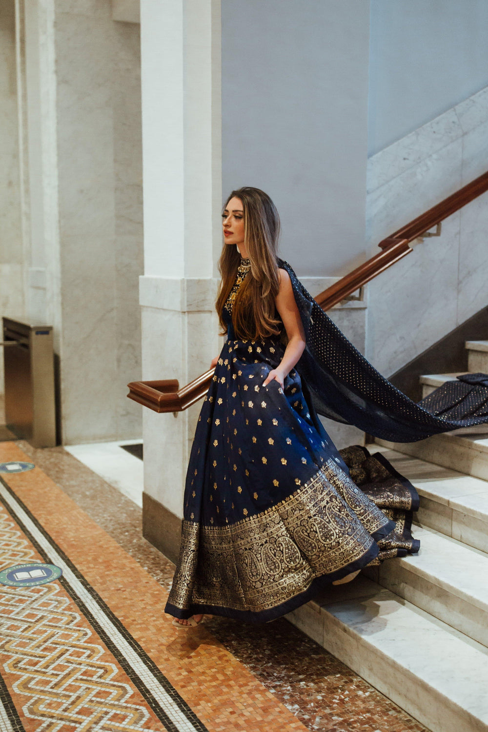 Blue Banarasi silk gown with velvet hand-embroidered torso, Banarasi Jacquard hem, and mukaish work drape.