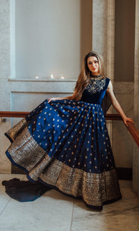 Blue Banarasi silk gown with velvet hand-embroidered torso, Banarasi Jacquard hem, and mukaish work drape.