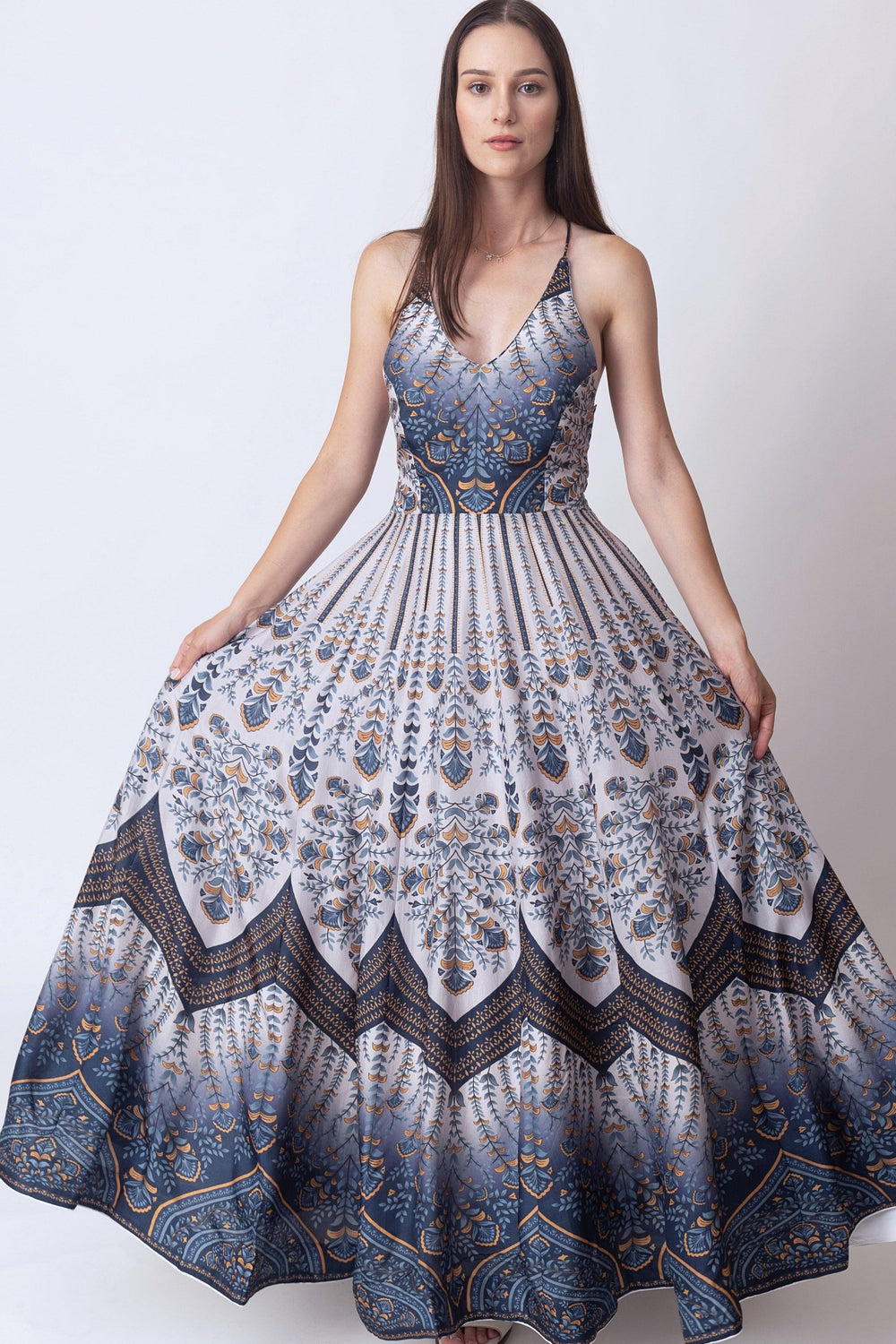 Blue V-neck silk maxi dress with elegant all-over print, shoulder straps, and a flowing skirt.
