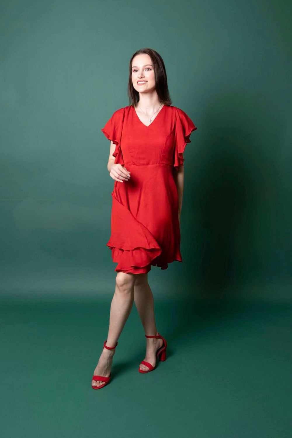 Red georgette sheath dress with butterfly sleeves, short silhouette, and mirror-embroidered belt.