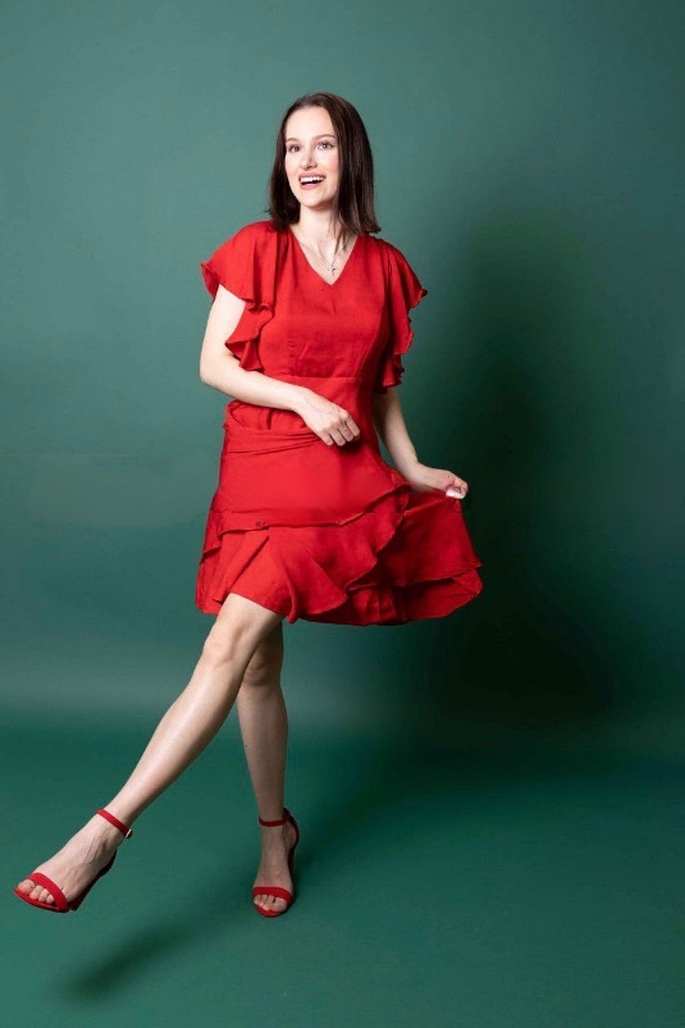 Red georgette sheath dress with butterfly sleeves, tiered skirt, and embroidered belt.