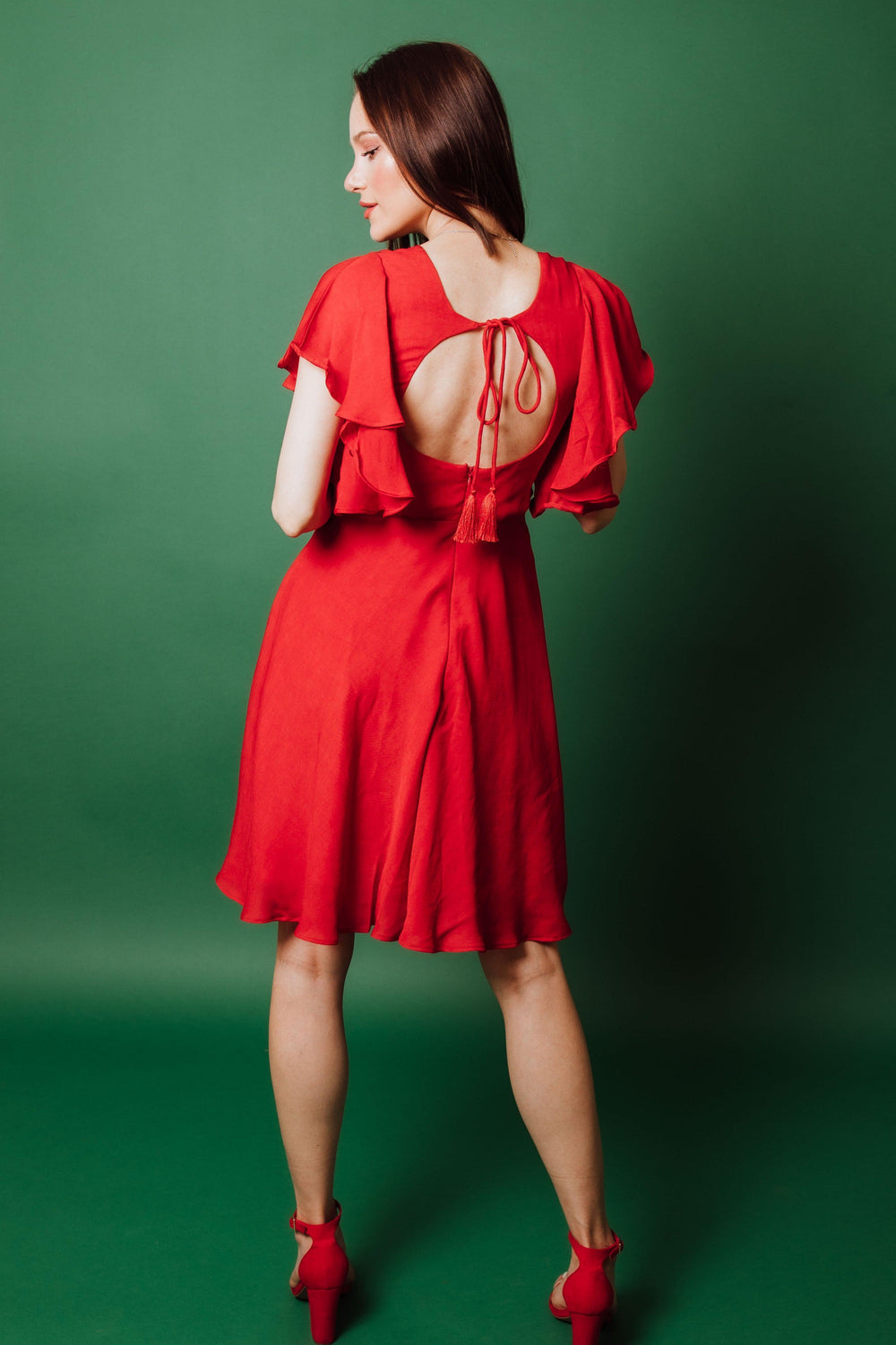 Red georgette sheath dress with butterfly sleeves, open back, and tie-up detail.
