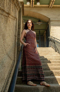 Maroon muslin silk maxi dress with Ajrakh floral print, halter neckline, and double slits.