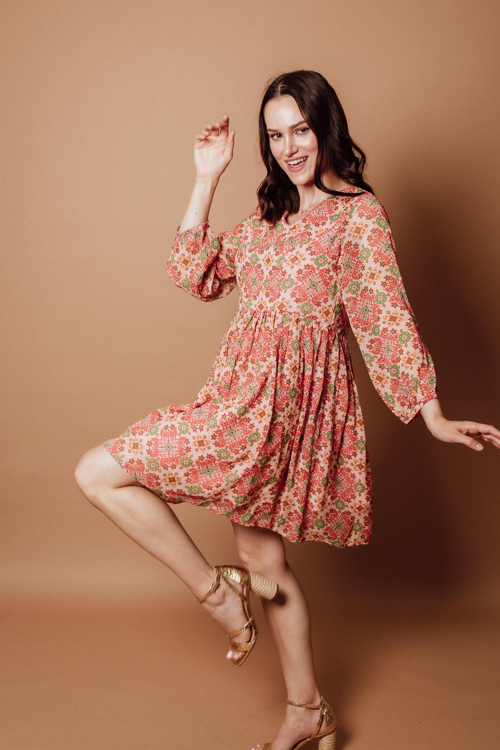 Floral Georgette V-Neck Mini Dress with coral, pink, and sage geometric print, long sleeves, and pleated skirt.