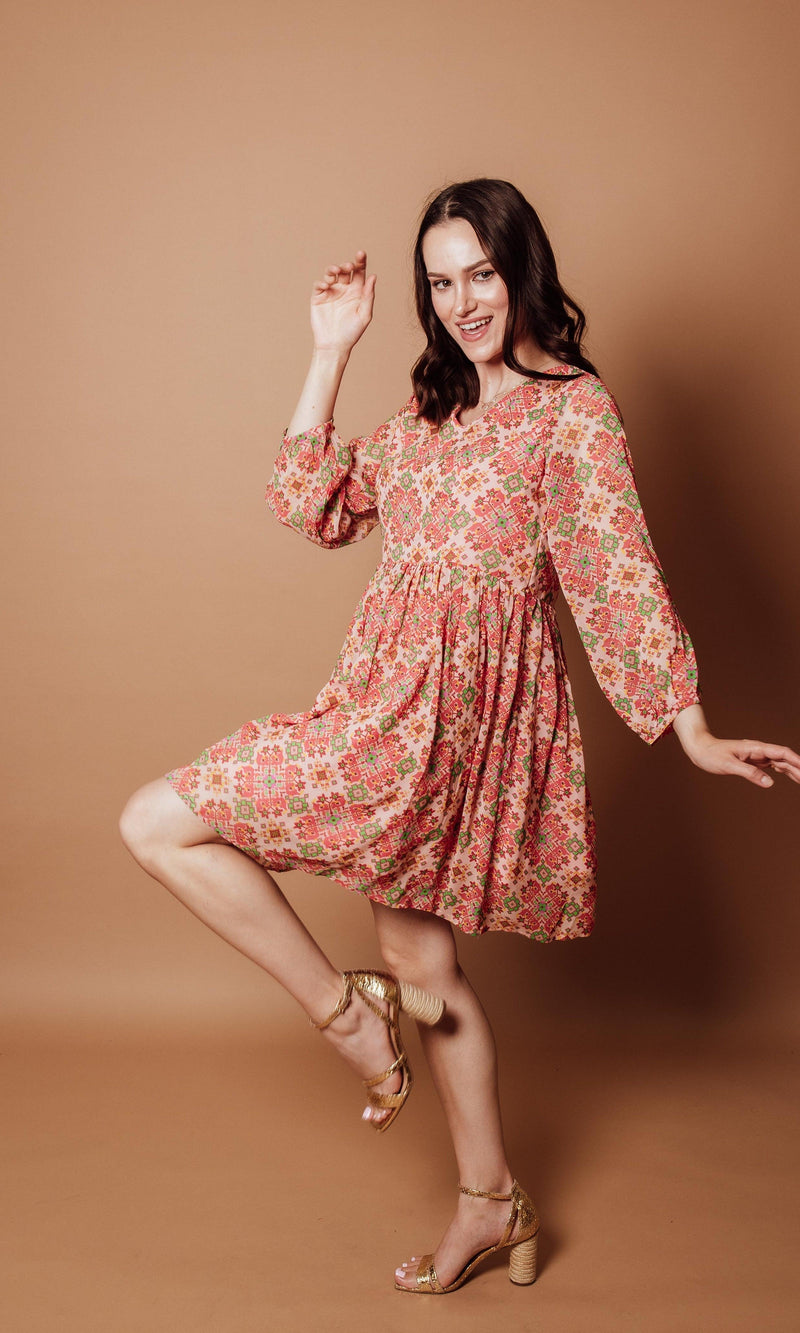 Floral Georgette V-Neck Mini Dress with coral, pink, and sage geometric print, long sleeves, and pleated skirt.