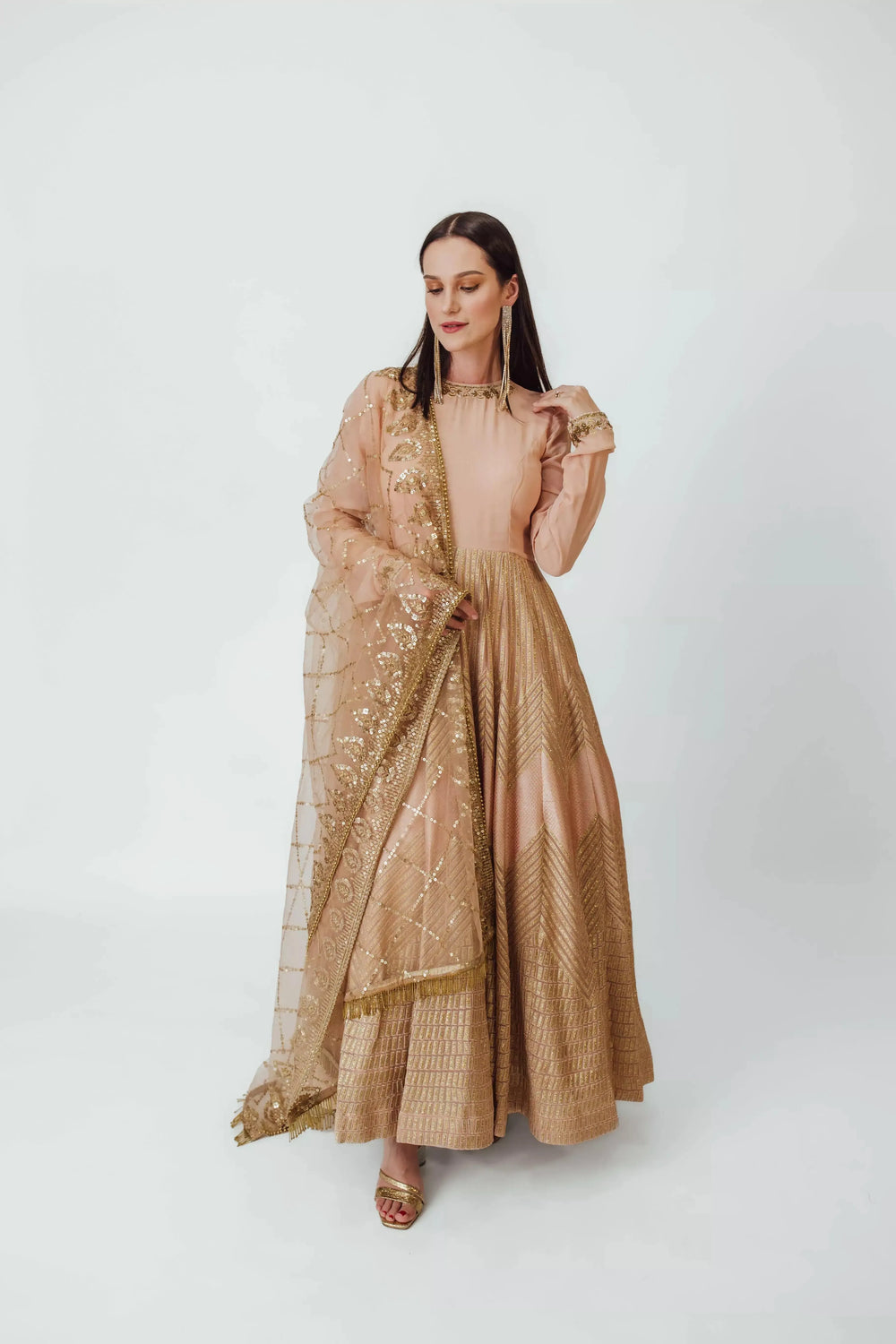 Maya Full Sleeve Gown in dusty peach georgette with gold embroidery and sequined net drape.